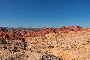 Scenic view of from Silica Dome viewpoint overlooking the Valley of Fire State Park in Mojave desert, Nevada, USA. Landscape of Aztek sandstone rock formations. Hot temperature in arid vegetation