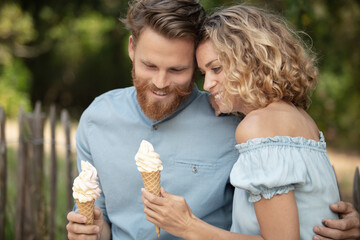 happy couple having date and eating ice cream