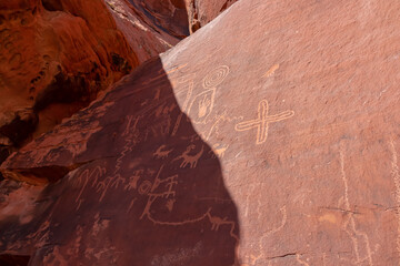 Close up view of Native American rock art (Petroglyphs) on red Aztek sandstone wall of Atlatl Rock in Valley of Fire State Park in Mojave desert, Nevada, USA. Ancient American history. Archeology site