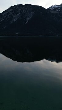Early morning at the Achensee with view from Top and a pure mountain reflection