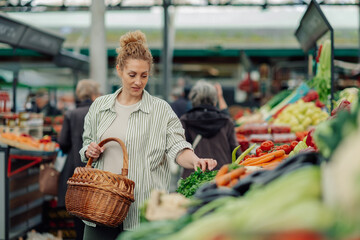 Shopper woman with basket choosing organic groceries at food market.