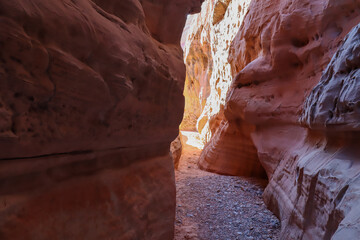 Hike in the narrow Kaolin Wash slot canyon along White Domes Hiking Trail in Valley of Fire State...