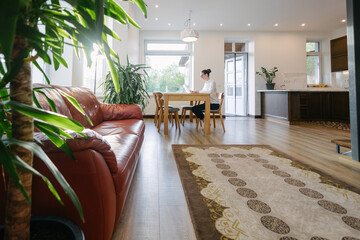 Woman working in modern private home interior