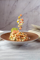 A fresh and colorful fruit salad featuring a variety of sliced fruits, beautifully presented on a white background. 