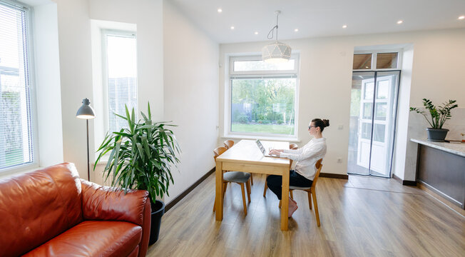 Woman working in modern private home interior