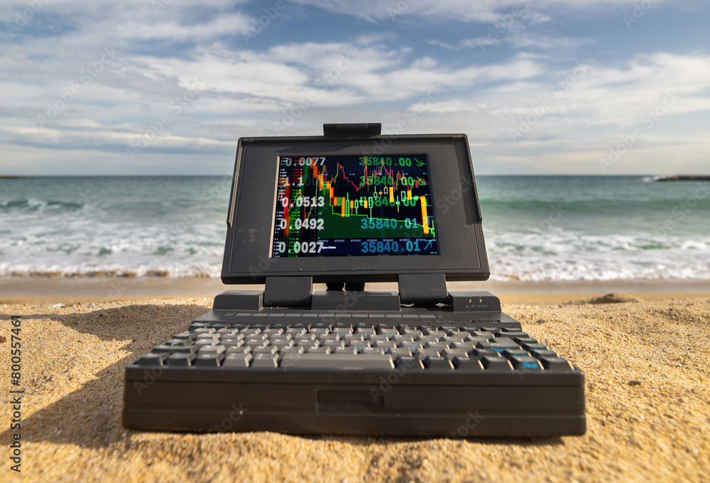 Poster laptop computer system by the sea with trading data on screen