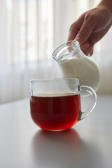 Pouring Cream into a Cup of Coffee