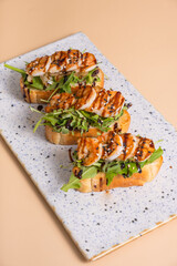 Bruschetta with fried shrimp and salad mix. Delicious snacks with seafood