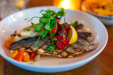 Grilled fish filet with vegetables.