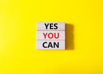 Yes You Can symbol. Concept word Yes You Can on wooden blocks. Beautiful yellow background. Business and Yes You Can concept. Copy space.