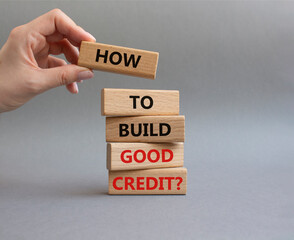 How to build good credit symbol. Concept words How to build good credit on wooden blocks. Beautiful grey background. Businessman hand. Business and How to build good credit concept. Copy space.