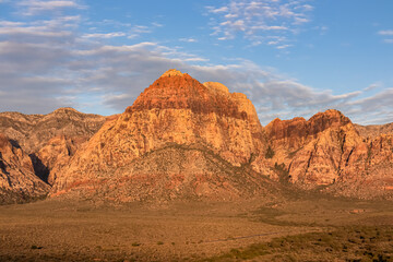 Scenic sunrise view of limestone peaks Mount Wilson, Bridge and Rainbow Mountain of Red Rock Canyon National Conservation Area in Mojave Desert near Las Vegas, Nevada, United States. Remote hiking