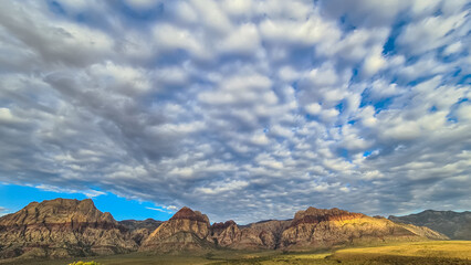 Scenic sunrise view of limestone peaks Mount Wilson, Bridge and Rainbow Mountain of Red Rock Canyon National Conservation Area in Mojave Desert near Las Vegas, Nevada, United States. Remote hiking