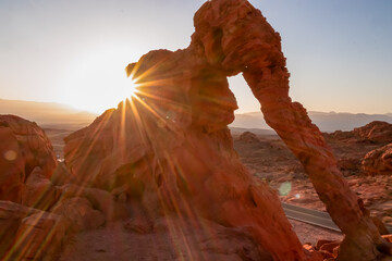 Panoramic sunrise view of the elephant rock surrounded by red and orange Aztec Sandstone Rock...