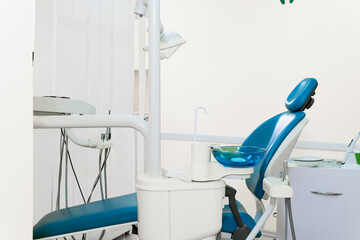 Dentist workspace with modern chair, equipment and instruments