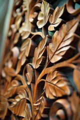 Fototapeta premium Dramatic lighting casts shadows on a wood carving of leaves, enhancing the 3D effect and texture