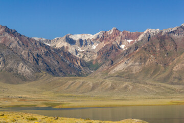 panoramic view over the Crowley lake to a iconic mountain range at a bright sunny summer day,...