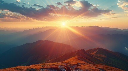   The sun illuminates the mountains afar as it ascends the peak