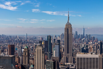 Vibrant urban skyline with towering skyscrapers and impressive architecture seen from Top of The Rock in New York. Empire State Building and One World Trade Center in the frame. Modern and lively city
