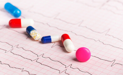 medical pills on the background of a cardiogram