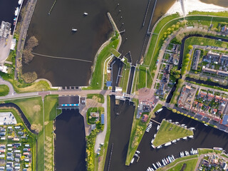 Aerial drone top down view of lock complex in Frisian city of Stavoren. Large pumping station...