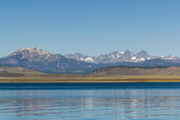 panoramic view over the Crowley lake to a iconic mountain range at a bright sunny summer day,...