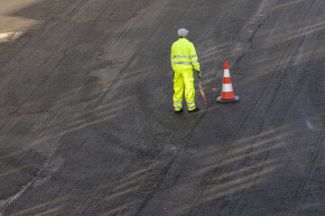 High angle view of a construction worker working on a road renovation