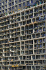 Facade of a tall building under construction. Abstract construction background.