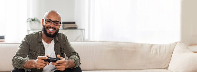 Man playing video game on console at home