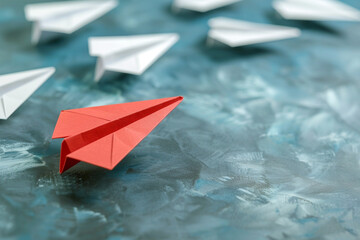 A single red paper plane leading white ones, embodying leadership, direction, and the courage to be different 