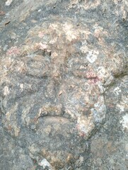 human face carved naturally on a rock