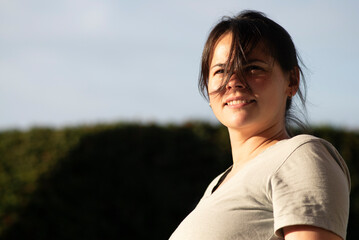 Portrait of a beautiful asian woman in the park at sunset