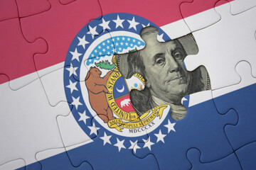 puzzle with the national flag of missouri state and usa dollar banknote. finance concept