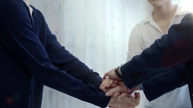 Team unity - business hand stack. Close-up of a diverse team stacking hands, symbolizing partnership and teamwork