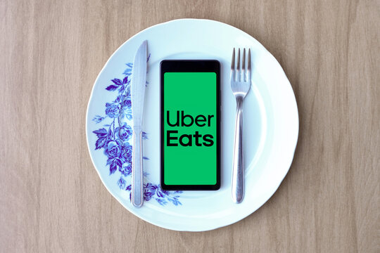 April 29, 2024, Brazil. In this photo illustration, the Uber Eats logo is displayed on a smartphone screen inside a plate with cutlery.