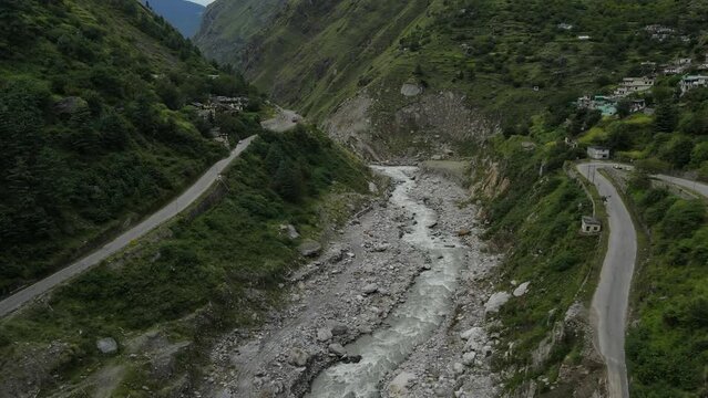 Aerial Drone shot of a river flowing in Mountains in uttarakhand. 