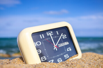 clock on a beach with sky and sea in background - 800591212