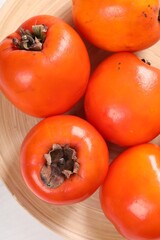 Delicious ripe persimmons on table, top view