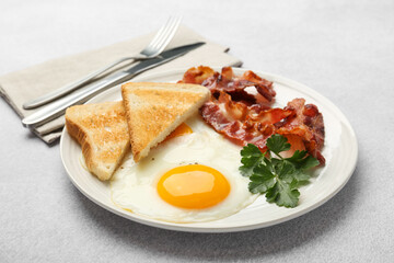 Delicious breakfast with sunny side up egg served on light table
