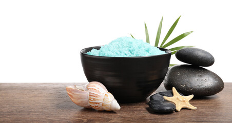 Light blue sea salt in bowl, spa stones, starfish, seashell and palm leaf on wooden table against...