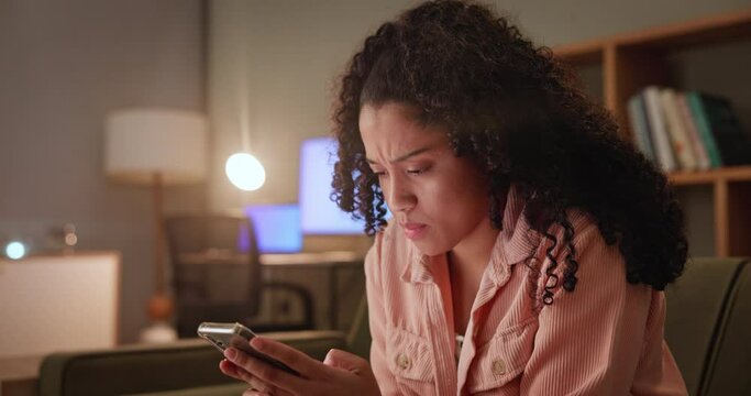 Angry, woman and smartphone on sofa with internet, online bullying or gossip on social media. Female person, frustrated and stress with tech for serious discussion, bad news or post on website