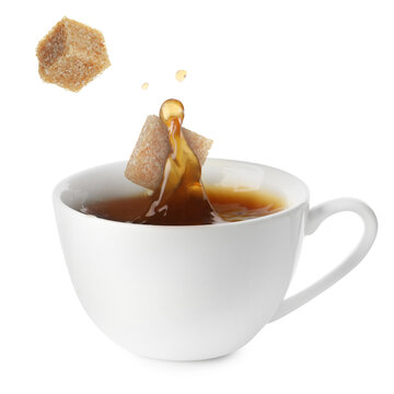 Coffee splashing in cup due to falling sugar cubes on white background