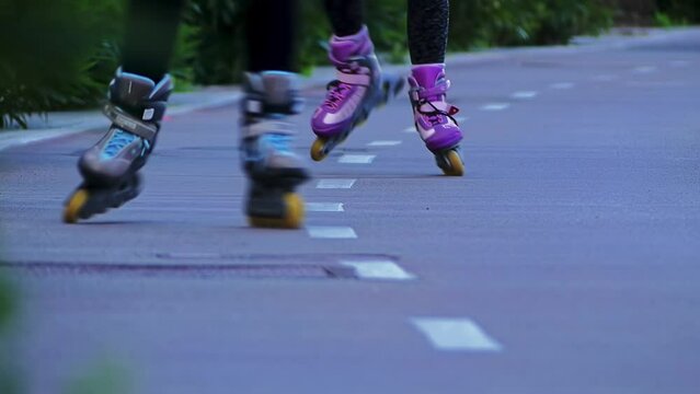 young people rollerblading on a special path in the city park