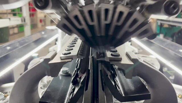 Industrial knitting machine for knitting textiles with seven guide bars of threads behind each other