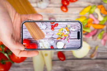 Top-down view of capturing delicious food with a phone camera, showcasing the art of food photography and culinary delights