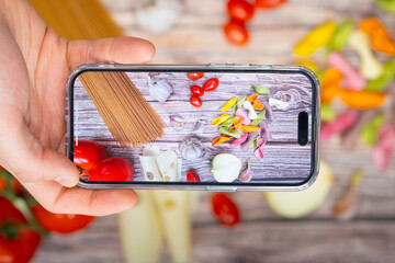 Top-down view of capturing delicious food with a phone camera, showcasing the art of food photography and culinary delights