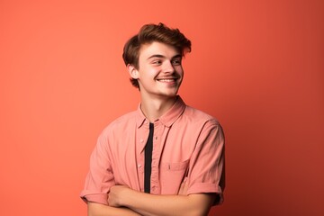 Fototapeta premium A young man in a pink shirt and black tie is smiling and looking at the camera