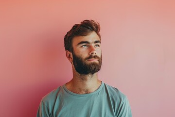 Fototapeta premium A man with a beard and a blue shirt is looking at the camera