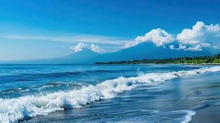 Pristine white-sand beach with gentle waves lapping on the shore, and a majestic mountain range looming in the distance under a clear blue sky