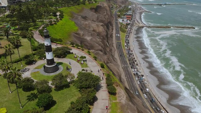 Aerial image of the city of Lima with a view of the boardwalk of Miraflores, the cliff and the green coast. 
